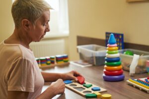 Mature woman on stroke therapy in rehabilitation room